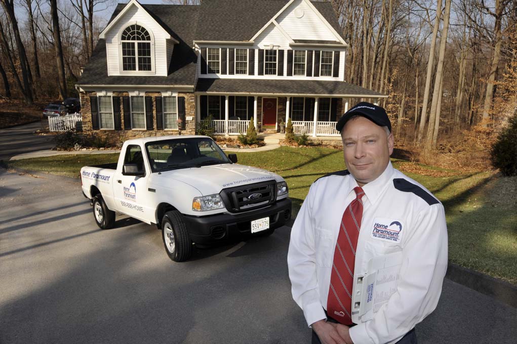 Home Paramount technician standing in front of company truck in front of customer's home